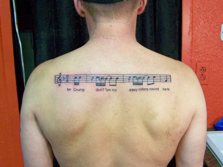 music-band-notes-tattoo-on-upper-back